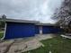 Home with blue siding and a concrete patio, perfect for outdoor relaxation and entertaining at 3162 Wallace Ave, Indianapolis, IN 46218