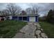 Cozy one-story home featuring blue siding, an attached garage, and a cracked driveway at 3162 Wallace Ave, Indianapolis, IN 46218