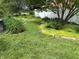 Landscaped backyard with mature trees and a lush lawn, perfect for outdoor relaxation at 3315 Hillcrest Dr, Columbus, IN 47203