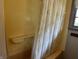 Bathroom featuring a vintage shower and bathtub, complete with a shower curtain and window at 3315 Hillcrest Dr, Columbus, IN 47203