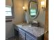 Bathroom with granite countertop, decorative lighting, and an oval mirror for a sleek look at 3315 Hillcrest Dr, Columbus, IN 47203