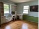 Bedroom with built-in shelving, desk and hardwood floors at 3315 Hillcrest Dr, Columbus, IN 47203