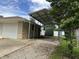 Carport next to the garage of the house, offering covered parking at 3315 Hillcrest Dr, Columbus, IN 47203