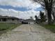Spacious driveway leading to a detached two-car garage, providing ample parking space for vehicles and recreational equipment at 3315 Hillcrest Dr, Columbus, IN 47203