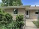 Exterior view with a chain link fence, manicured lawn, and landscaping at 3315 Hillcrest Dr, Columbus, IN 47203