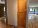 Hallway features an integrated cabinet and hardwood flooring, showcasing the home's functionality at 3315 Hillcrest Dr, Columbus, IN 47203