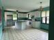 Bright kitchen with white cabinets, stainless steel refrigerator and kitchen island at 3315 Hillcrest Dr, Columbus, IN 47203