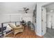 Cozy attic space with wood flooring, chairs, fan, and access to the bathroom at 333 S Fourth St, Zionsville, IN 46077