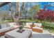 Inviting back patio with wicker furniture and a view of the spacious, tree-lined backyard at 333 S Fourth St, Zionsville, IN 46077