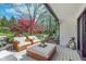 Outdoor deck featuring wicker patio furniture and view of landscaped backyard at 333 S Fourth St, Zionsville, IN 46077