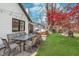 Outdoor dining area with brick patio, lush lawn, and easy access to the home's interior at 333 S Fourth St, Zionsville, IN 46077