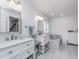 Bright bathroom with double vanity, soaking tub, and large mirrors at 333 S Fourth St, Zionsville, IN 46077