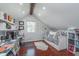 Attic bedroom space with daybed, wood beam and window with outdoor view at 333 S Fourth St, Zionsville, IN 46077
