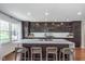 Modern kitchen featuring a large island with seating, dark wood cabinetry, and sleek stainless steel appliances at 333 S Fourth St, Zionsville, IN 46077