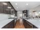 Contemporary kitchen featuring dark wood cabinets, stainless steel appliances, and a spacious countertop with a breakfast bar at 333 S Fourth St, Zionsville, IN 46077