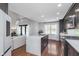Modern kitchen with an island with a quartz countertop, stainless steel appliances, and wood floors at 333 S Fourth St, Zionsville, IN 46077