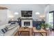 Inviting living room showcasing a cozy fireplace, modern decor, and views to the outdoor patio at 333 S Fourth St, Zionsville, IN 46077