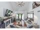 Open-concept living area with high ceilings, large windows, fireplace, and seamless flow to the kitchen and dining area at 333 S Fourth St, Zionsville, IN 46077