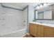 A full bathroom featuring white tile walls, wood flooring and a vanity at 3433 Brouse Ave, Indianapolis, IN 46218