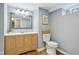 A half bathroom featuring wood flooring and a wood vanity at 3433 Brouse Ave, Indianapolis, IN 46218