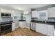 Modern kitchen featuring stainless appliances, granite counters and bright, white cabinetry at 3433 Brouse Ave, Indianapolis, IN 46218