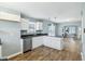 Kitchen with white cabinets and stainless steel appliances, and a seamless flow into the living areas at 3433 Brouse Ave, Indianapolis, IN 46218