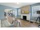 Open living room featuring a fireplace, hardwood floors, and arched doorway to the modern kitchen at 3433 Brouse Ave, Indianapolis, IN 46218