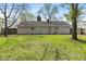 Large backyard with a well manicured lawn and mature trees at 3703 Dubarry Rd, Indianapolis, IN 46226