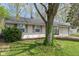 Traditional home featuring a well-manicured lawn and mature tree surrounded by decorative brick edging at 3703 Dubarry Rd, Indianapolis, IN 46226