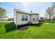 The house features a large green yard, a wood deck, and mature trees at 376 Lake Ridge Ln, Greenwood, IN 46142