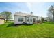 Charming backyard with green grass, wooden deck and home's exterior at 376 Lake Ridge Ln, Greenwood, IN 46142