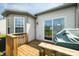 Backyard wooden deck with a covered grill and a sliding glass door to home interior at 376 Lake Ridge Ln, Greenwood, IN 46142