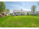Spacious backyard with a well-maintained lawn and wooden patio, perfect for outdoor gatherings at 376 Lake Ridge Ln, Greenwood, IN 46142