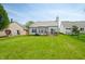 A large green backyard with a wood deck and home's exterior at 376 Lake Ridge Ln, Greenwood, IN 46142