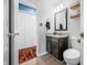 Stylish half bath with dark vanity, granite countertop, and wood-look tile flooring at 376 Lake Ridge Ln, Greenwood, IN 46142