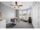 Bright bedroom featuring neutral carpet, a ceiling fan, and a large window at 376 Lake Ridge Ln, Greenwood, IN 46142