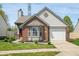 Charming brick and siding home with manicured lawn and bay window at 376 Lake Ridge Ln, Greenwood, IN 46142