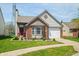 Well-maintained home featuring brick accents, a bay window, and lush landscaping at 376 Lake Ridge Ln, Greenwood, IN 46142