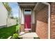 Inviting entryway with a bold red door and brick accents at 376 Lake Ridge Ln, Greenwood, IN 46142