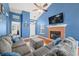 Cozy living room with a brick fireplace, large TV, and comfortable seating at 376 Lake Ridge Ln, Greenwood, IN 46142
