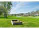 Picturesque pond view with a fountain, surrounded by lush greenery and neighborhood homes at 376 Lake Ridge Ln, Greenwood, IN 46142