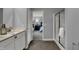 Stylish bathroom with double vanity, a glass enclosed shower, and an open doorway to the bedroom at 4105 Ashton View Ln, Indianapolis, IN 46268