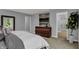 Relaxing bedroom showcases a wooden dresser and a neutral color scheme to create a peaceful retreat at 4105 Ashton View Ln, Indianapolis, IN 46268