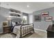 Bright bedroom featuring a bed with decorative pillows and artwork, and shelving filled with toys at 4105 Ashton View Ln, Indianapolis, IN 46268