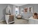 Charming Bedroom with white crib, cozy chair, and cute animal-themed artwork at 4105 Ashton View Ln, Indianapolis, IN 46268