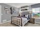 Stylish bedroom with metal bed frame and decor, with ample natural light from the window at 4105 Ashton View Ln, Indianapolis, IN 46268