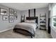 Nicely decorated bedroom with dinosaur themed artwork, gray walls, striped bedding and matching dark wood furniture at 4105 Ashton View Ln, Indianapolis, IN 46268