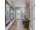 Inviting foyer with wood floors, mirrors, art, and a glimpse of natural light at 4105 Ashton View Ln, Indianapolis, IN 46268