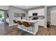 Modern kitchen with an island, stainless steel appliances, white cabinets, and seating for three at 4105 Ashton View Ln, Indianapolis, IN 46268