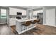Well-lit kitchen featuring stainless steel appliances, white cabinets, a kitchen island with seating, and modern finishes at 4105 Ashton View Ln, Indianapolis, IN 46268